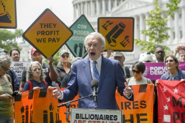 Activists holding signs against the “Big, Beautiful Bill” near the U.S. Capitol