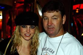 Britney Spears standing next to Jamie Spears, both smiling, taken during the conservatorship years.