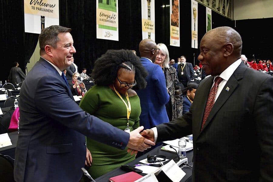 Leaders shaking hands, showing the tension between principle and pragmatism.