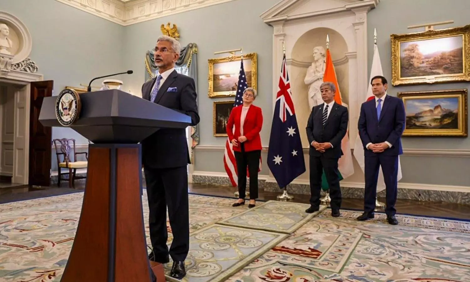 Dr. S. Jaishankar standing against podium.