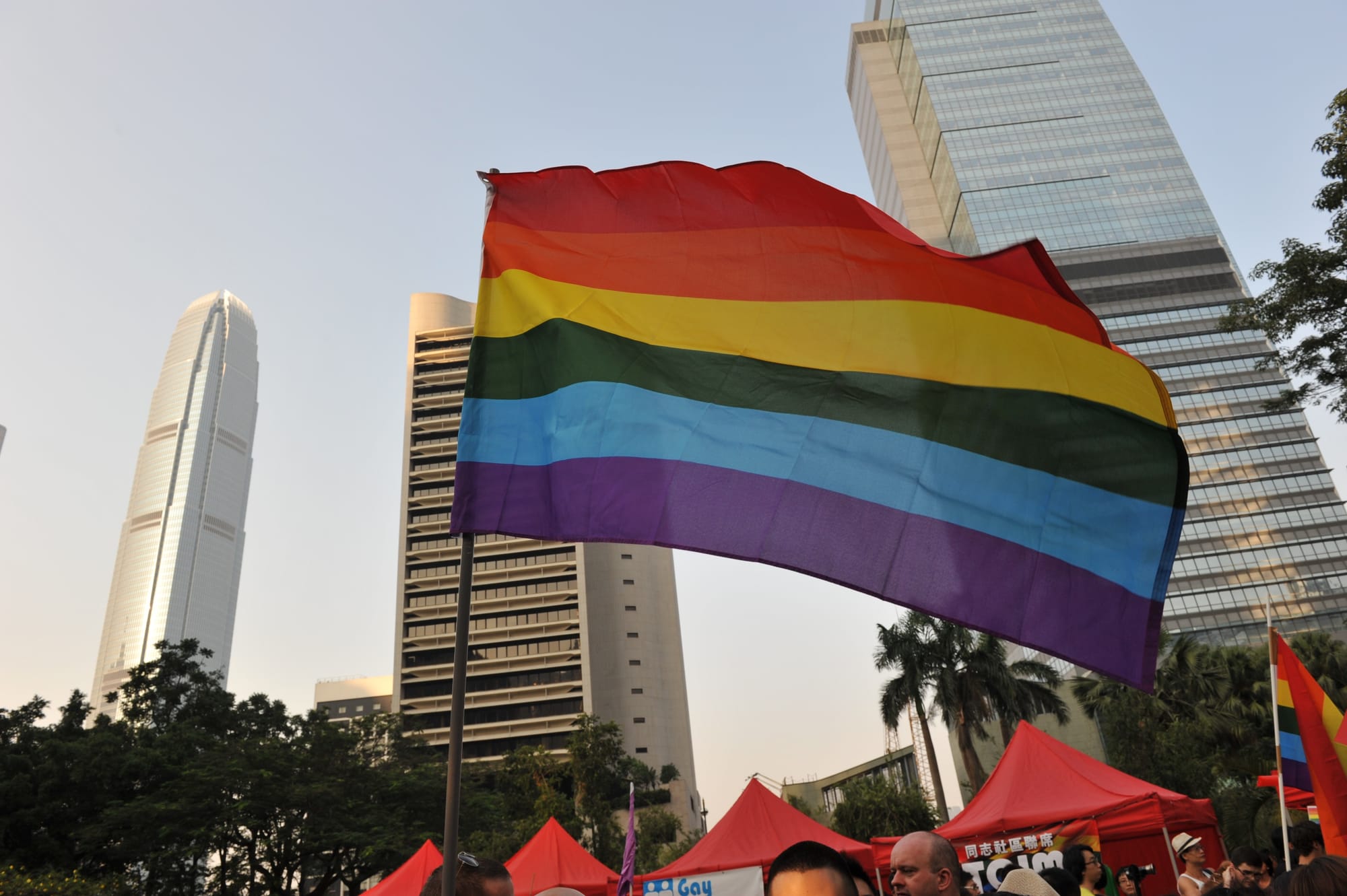 Rainbow pride flag against city skyline in Hong Kong