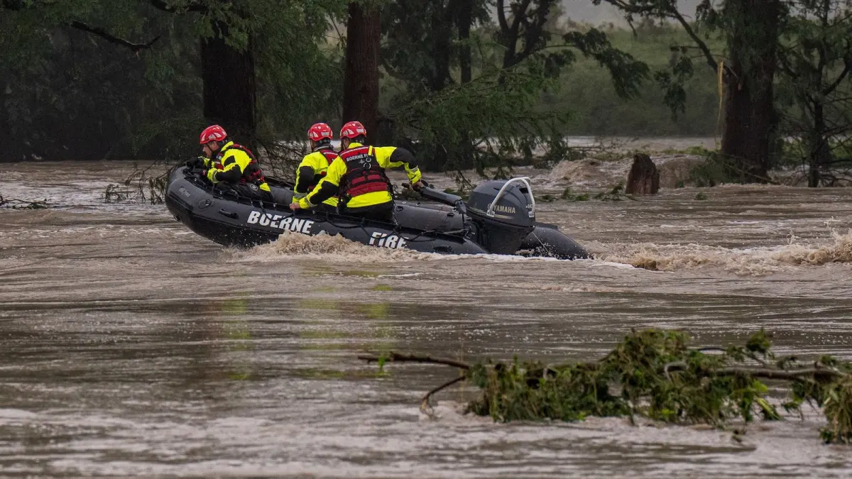 Rescue crew from Boerne Fire Department in an inflatable boat during flood response operations.