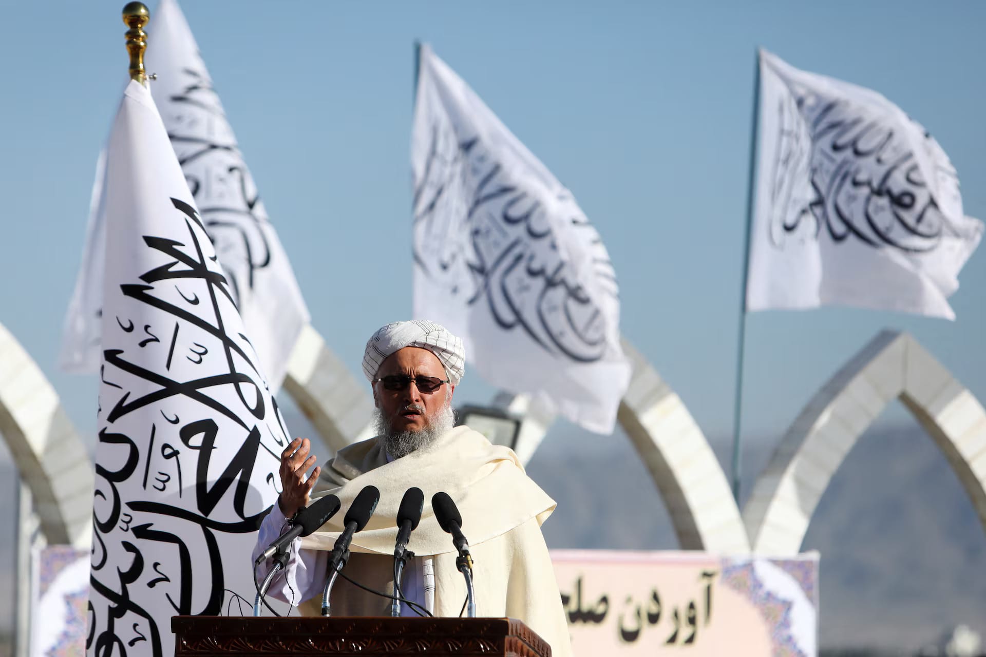 A Taliban flag-raising ceremony symbolizing the group’s consolidation of power and the backdrop for international recognition.