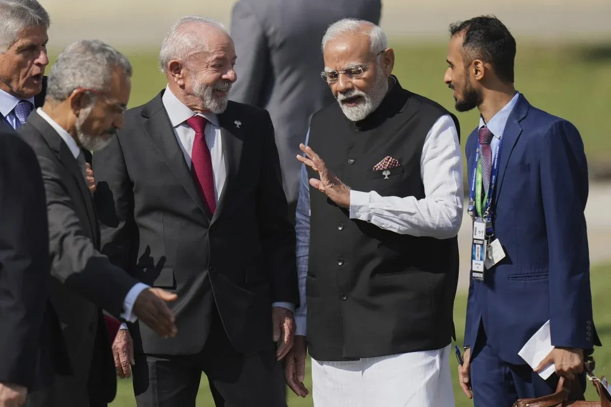 PM Modi engaging in friendly conversation with President Lula and other BRICS officials at the summit venue.