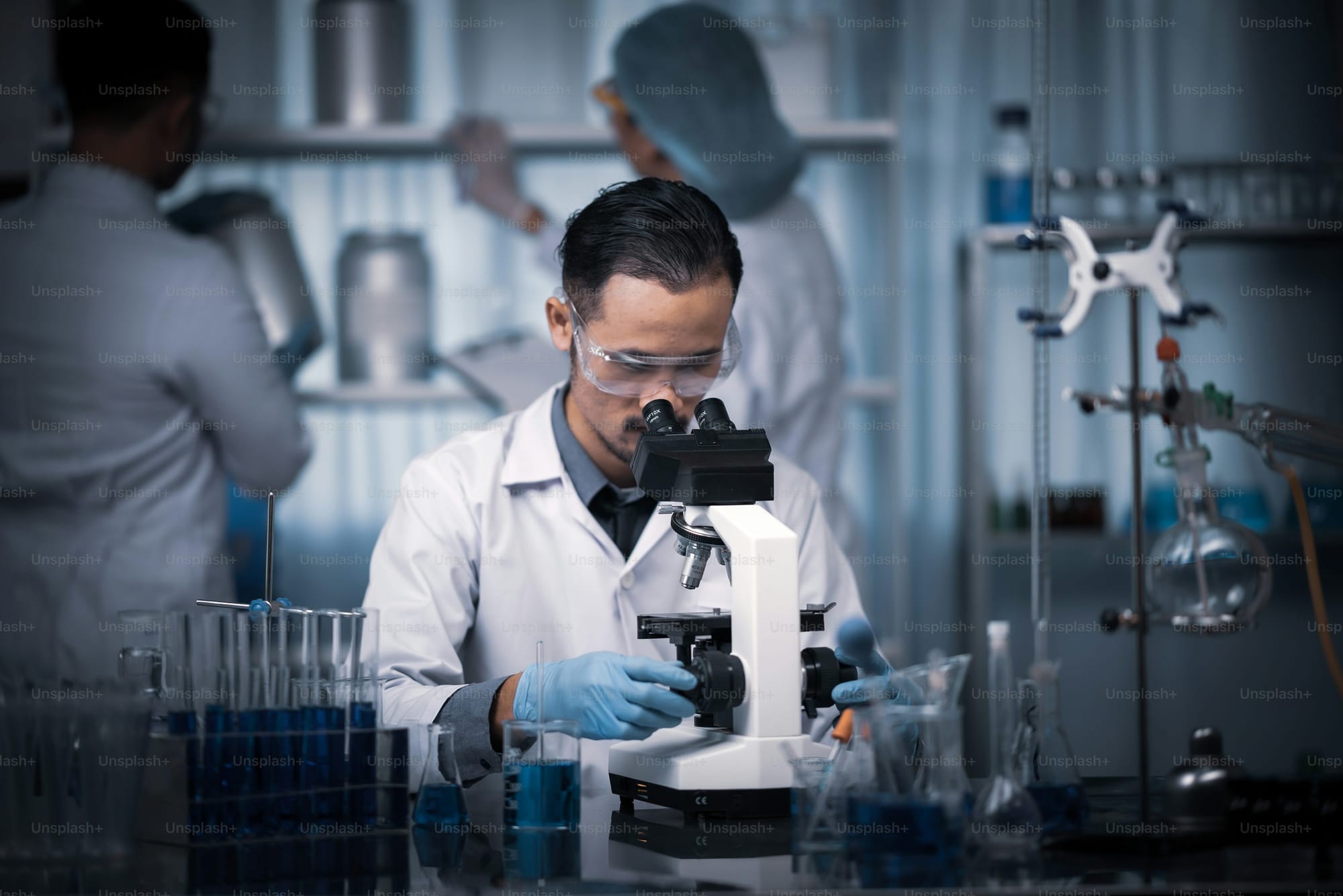 Scientist examining DNA samples under a microscope in a modern lab
