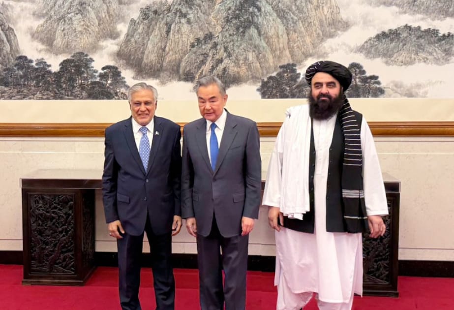 Foreign ministers from Pakistan, China, and Afghanistan stand together during trilateral talks aimed at strengthening regional cooperation.