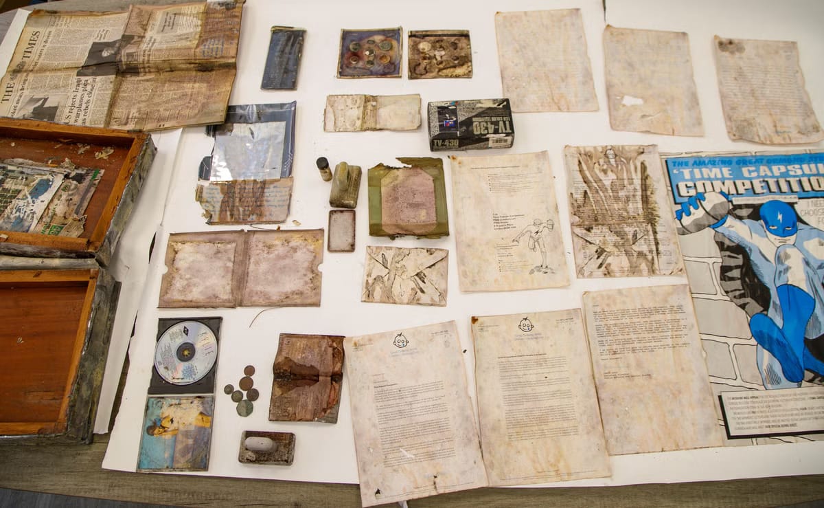 A curated tabletop spread displaying the recovered artifacts, nostalgic tokens of the early 1990s, now offering a nostalgic window into that era.
