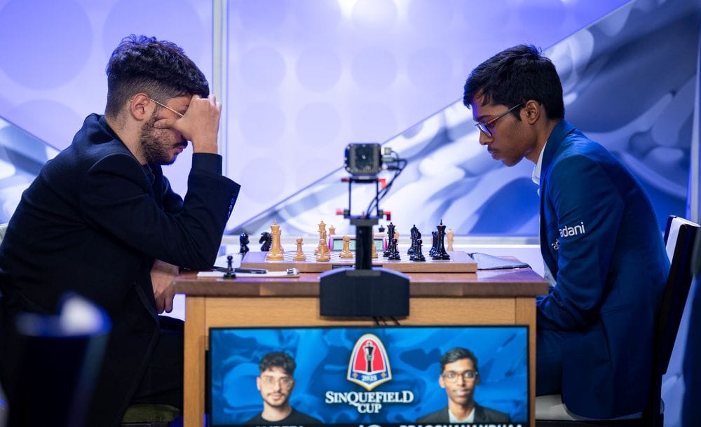 Chess players deeply focused during a Sinquefield Cup 2025 match, with the tournament logo and player portraits displayed on the board.