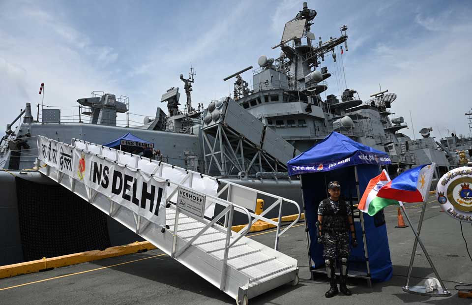 The Indian Navy’s INS Delhi docked in the Philippines, with personnel and flags of India and the Philippines visible during a naval drill or port call.