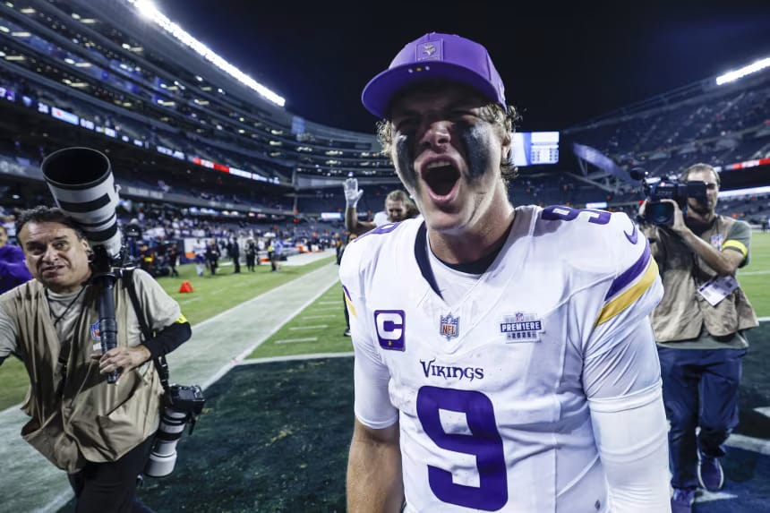 NFL player from the Minnesota Vikings celebrating passionately on the field after a game.