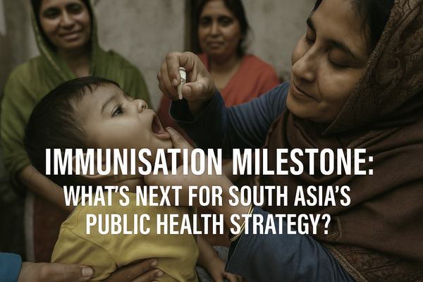 A healthcare worker administers a vaccine to a young girl at a crowded immunisation center in South Asia, highlighting regional public health success.