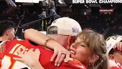 Taylor Swift embraces an NFL player in a heartfelt hug after the Super Bowl victory, surrounded by celebrations.