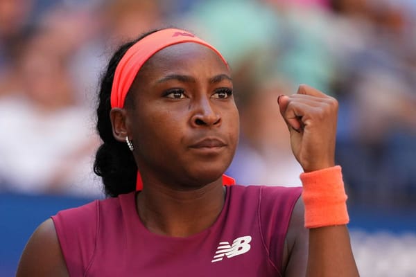 Coco Gauff pumps her fist in determination during a match at the US Open.
