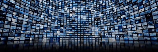 A large curved digital video wall displaying hundreds of blue-tinted thumbnail images, symbolizing media, entertainment, and digital content streaming.