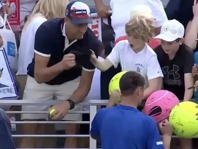 A viral moment showing the scene where Piotr Szczerek reaches over to grab the cap as it is being handed to the boy.
